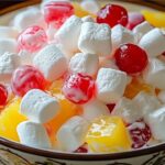 This easy and sweet Junk Yard Salad combines classic ingredients like cherry pie filling, crushed pineapple, and marshmallows for a nostalgic treat. Perfect for potlucks or family gatherings!