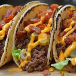 If you're looking to combine the best of both worlds—tacos and cheeseburgers—then these Loaded Bacon Cheeseburger Tacos are your new favorite recipe. Packed with seasoned ground beef, crispy bacon, and all your favorite burger toppings, these tacos offer a fun, easy-to-make meal that everyone will love. Plus, they come together in just 20 minutes, making them perfect for a quick weeknight dinner or a casual get-together.