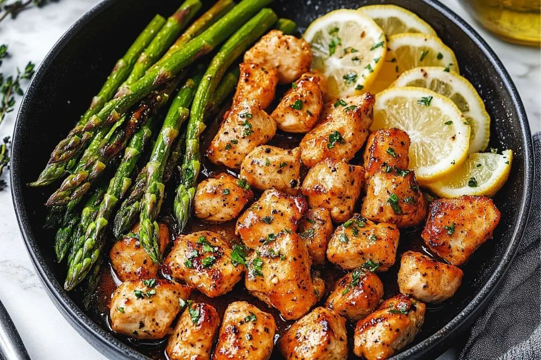 Tender chicken bites sautéed in garlic butter and served with bright, lemony asparagus. This quick and flavorful dish is perfect for a weeknight meal that's both light and satisfying.