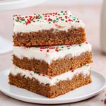 These Chewy Gingerbread Bars Recipe topped with cream cheese frosting are the perfect holiday treat! Full of warm spices like cinnamon, ginger, and cloves, these easy-to-make bars are a festive delight for any Christmas gathering. Ready in just over an hour!